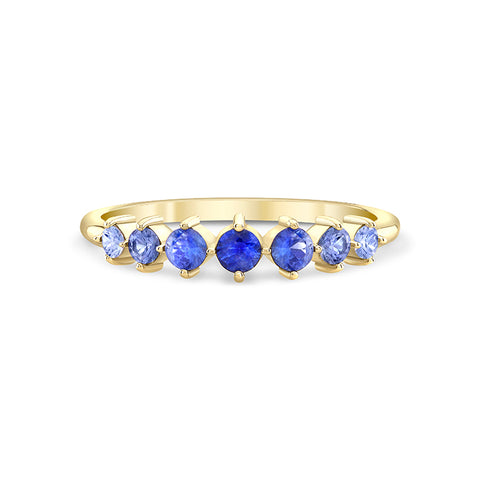 gold ring with seven blue sapphires