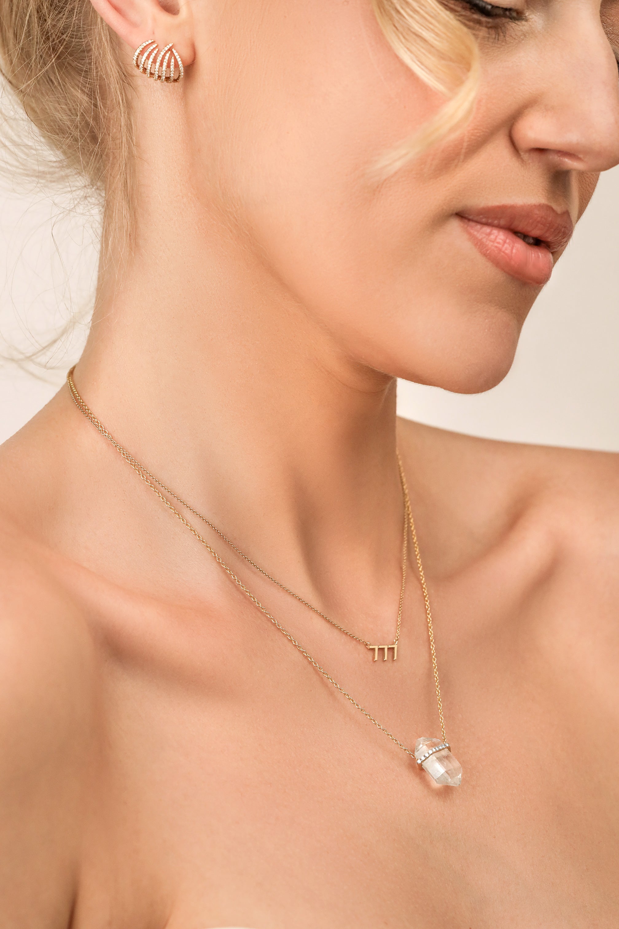 woman wearing two necklaces and diamond earrings by carter eve jewelry