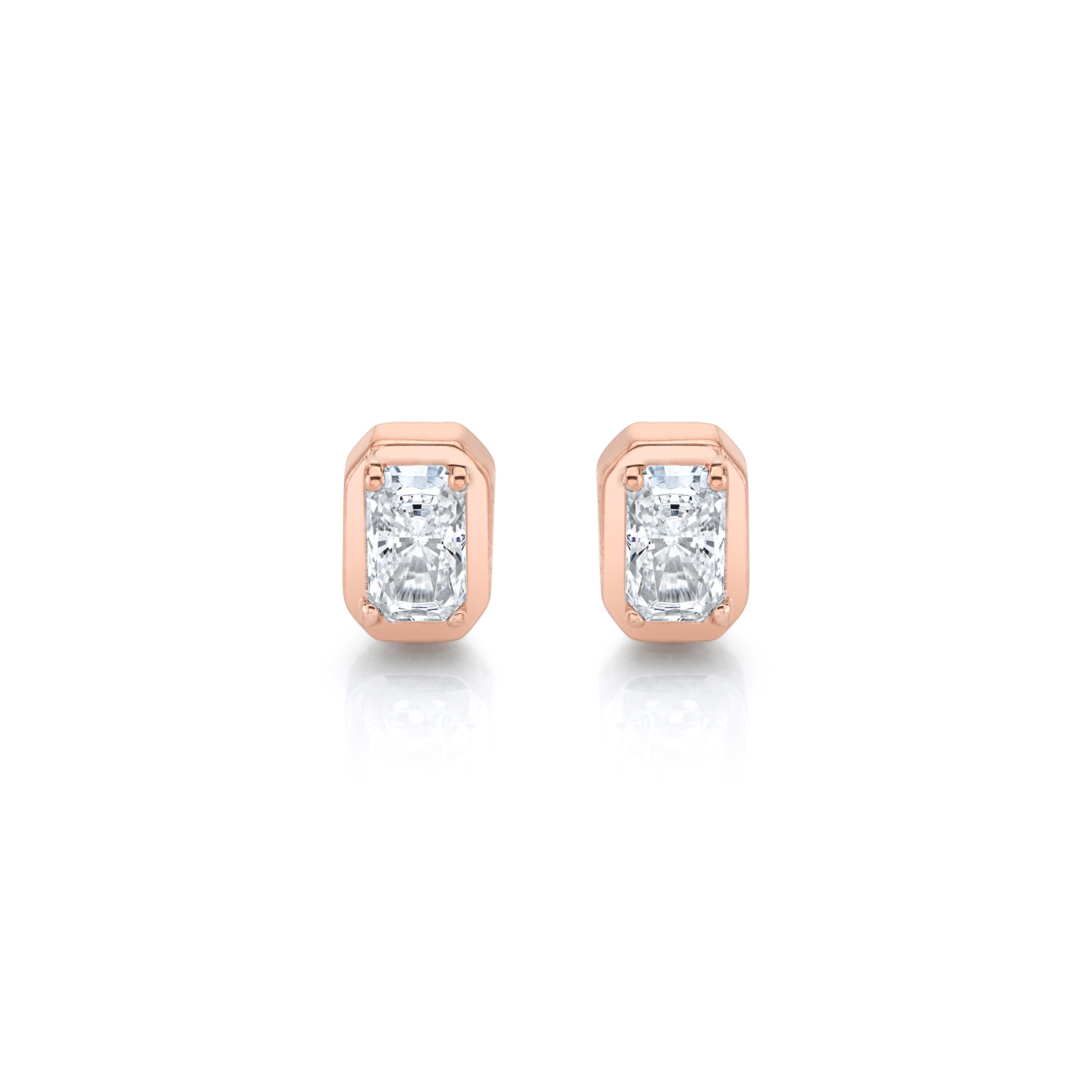 Rose gold earrings with clear gemstones on a white background