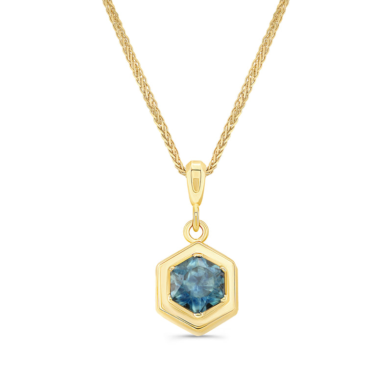 A hexagon-cut Montana sapphire pendant necklace in 14K gold, with a gold chain.