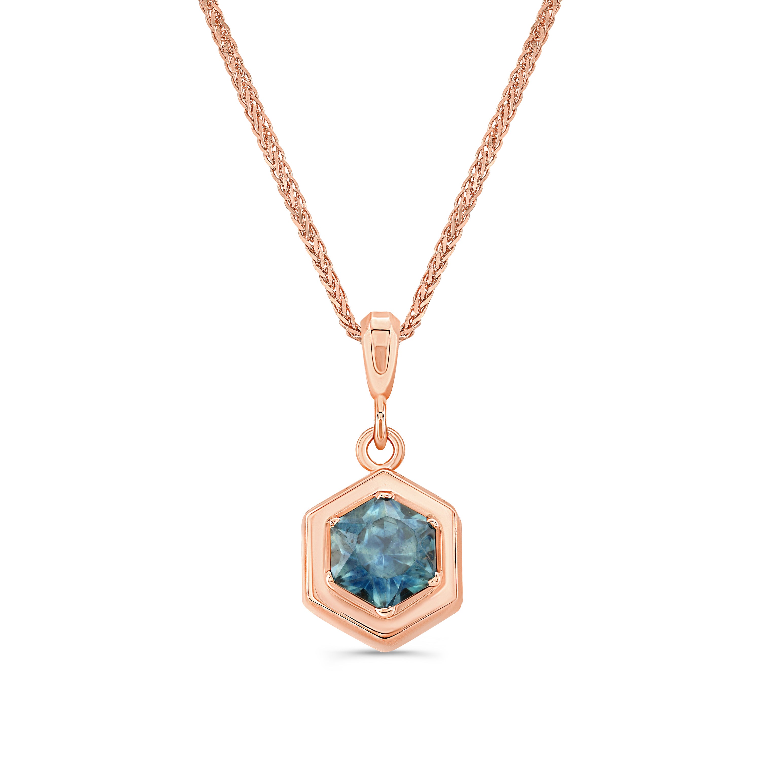 Rose gold necklace with a hexagon cut montana sapphire pendant on a white background