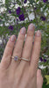 video of woman wearing purple sapphire ring and diamond ring